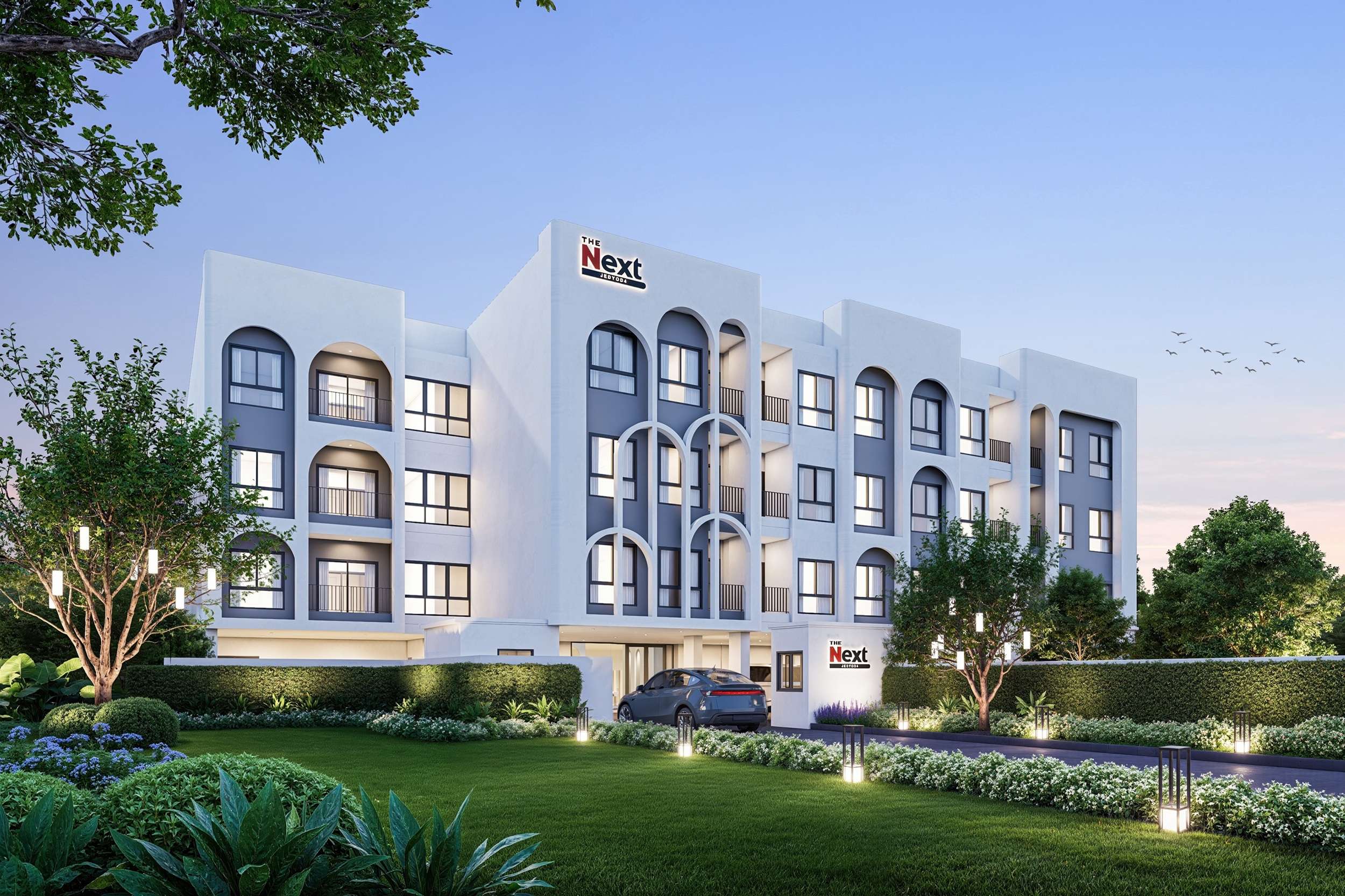 ภาพจำลองบรรยากาศภายนอกของโครงการคอนโดมิเนียม เดอะ เน็กซ์ เจ็ดยอด 4 (THE NEXT JEDYOD 4) คอนโดมิเนียม Low Rise สไตล์โมเดิร์น โทนสีขาวสลับเทา ตั้งอยู่ท่ามกลางพื้นที่สีเขียว