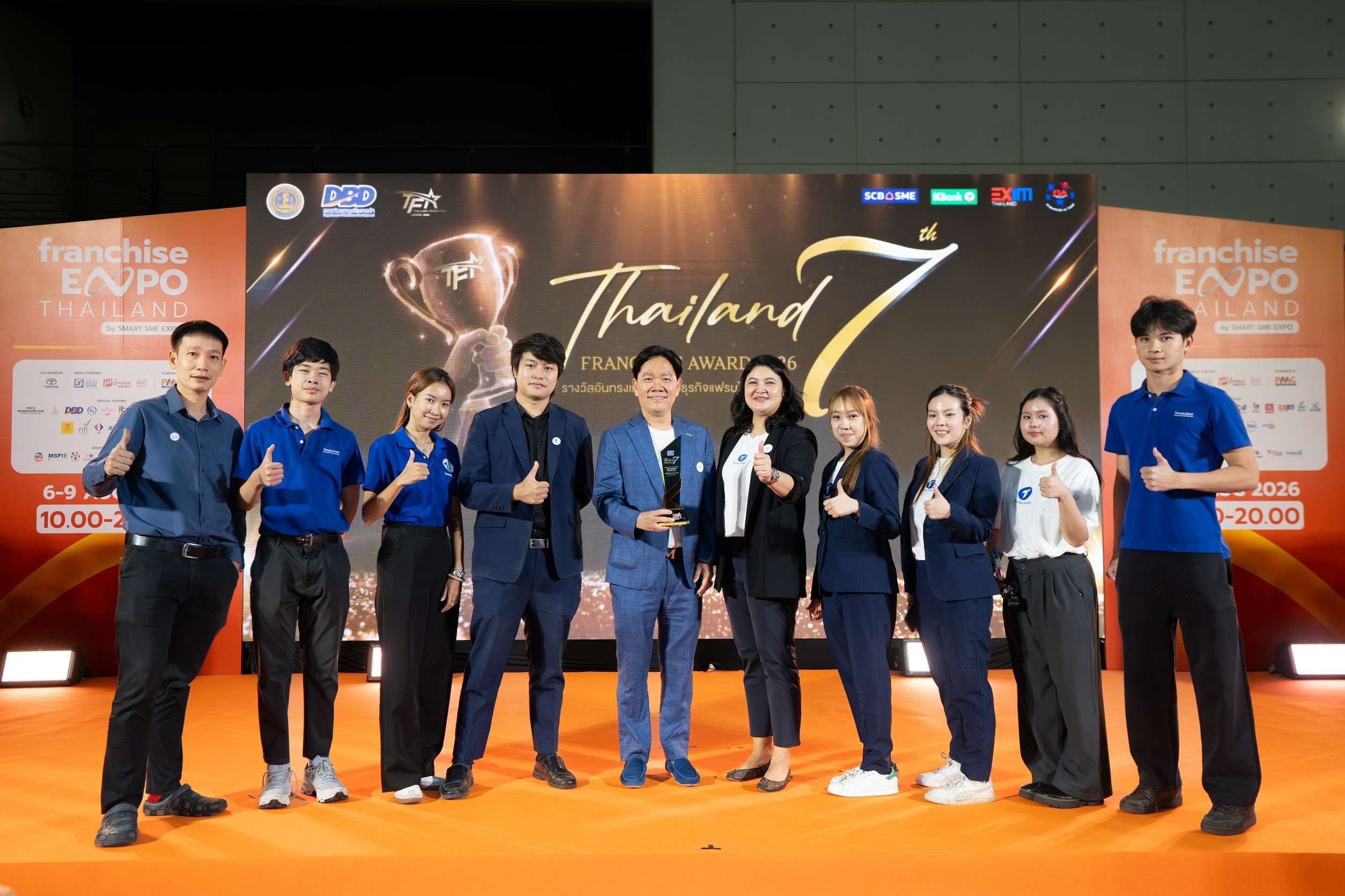 ทีมผู้บริหารและพนักงาน Trendy Wash by Urbanway ถ่ายภาพร่วมกันบนเวทีงาน Thailand Franchise Award 2026