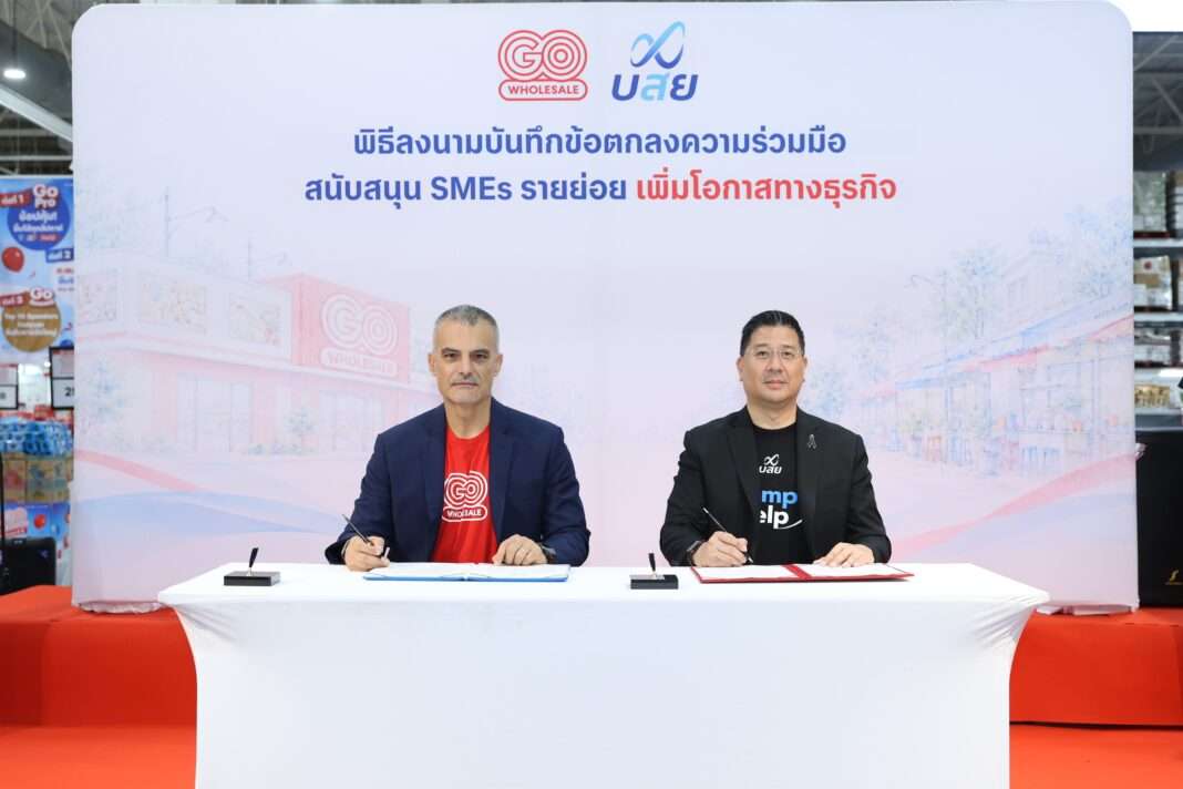 พิธีลงนามบันทึกข้อตกลงความร่วมมือระหว่างโก โฮลเซลล์ และ บสย. เพื่อสนับสนุนผู้ประกอบการ SMEs รายย่อย เพิ่มโอกาสทางธุรกิจ โดยมีผู้บริหารจากทั้งสององค์กรร่วมลงนามที่โต๊ะบนเวที